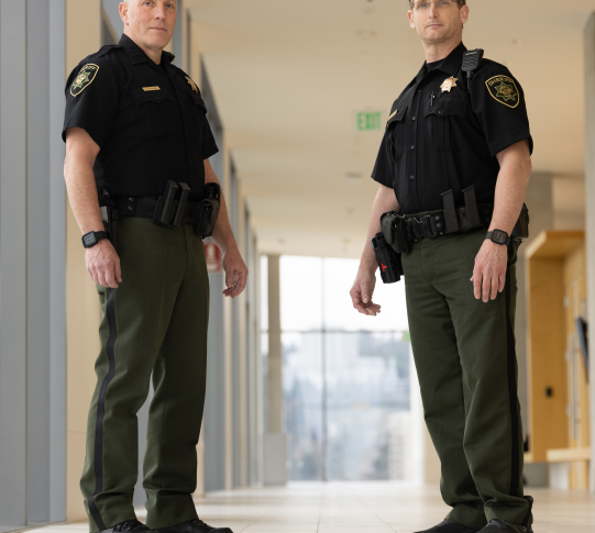 Two Court Services Unit deputies stand in a Central Courthouse corridor.