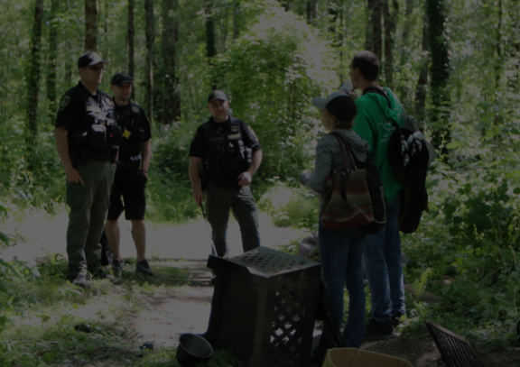 HOPE team talks with unhoused people in Troutdale Park.