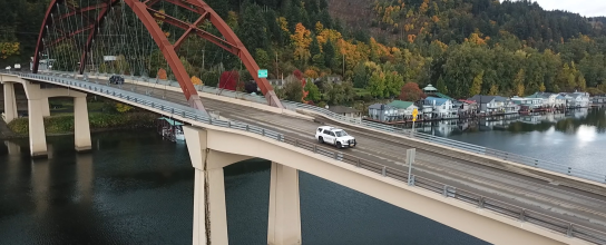Patrol car drives across Sauvie Island Bridge.