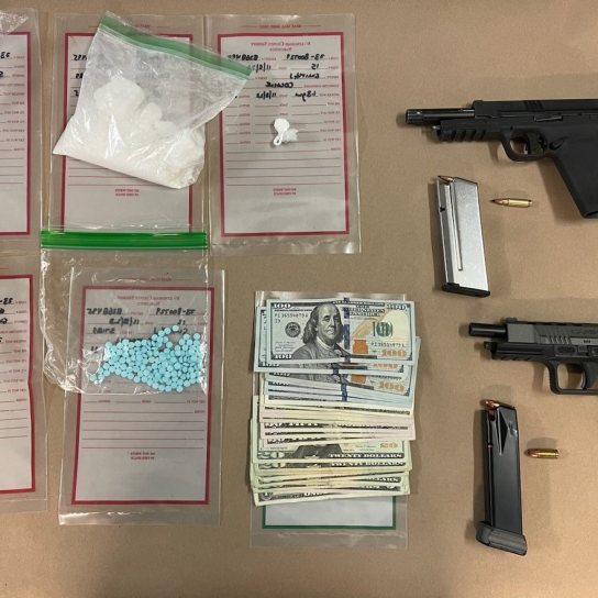 Firearms and drugs on table.