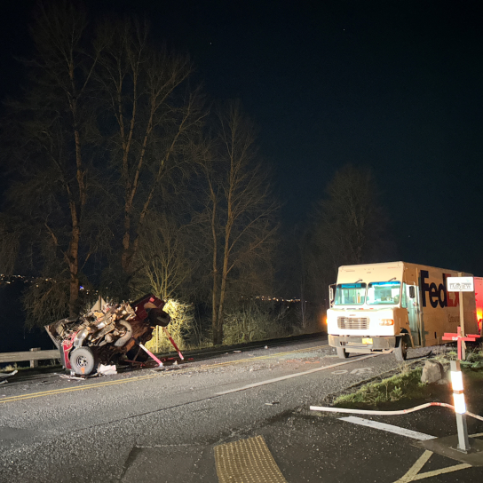 Crashed Ford F-150 on the side of the road at night.