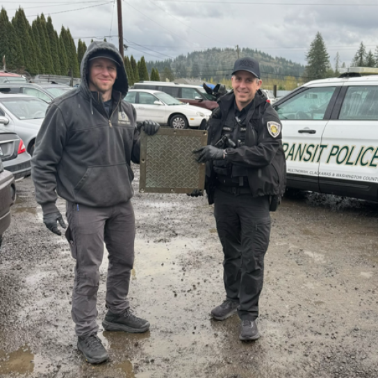 MCSO and Port of Portland Police hold a recovered stolen brass plate following a search warrant (MCSO photo)