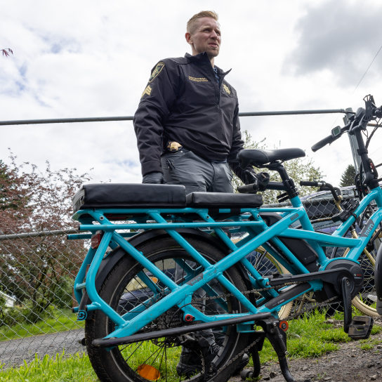A sergeant with the Multnomah County Sheriff’s Office looks over a stolen bike recovered during a search warrant. 