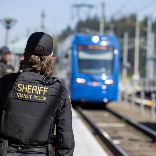 Transit Police at TriMet station with MAX approaching