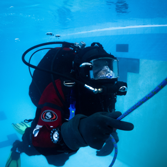 Deputy is in full scuba suit doing a practice dive in a pool.