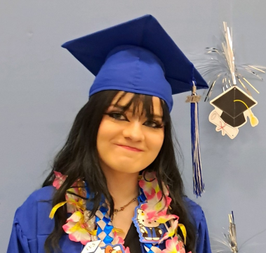 Graduation photo of Elaina in a cap and gown.
