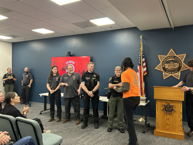 Sheriff Nicole Morrisey O’Donnell addressing the MCSOSAR graduates and shaking the hand of one of the graduates. 