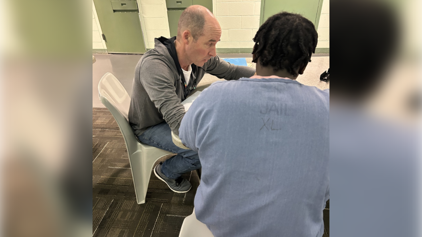 MESD Instructor Tyler Duvall teaches an adult in custody at MCDC math.