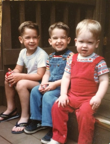 Detective Jonathan Zwick (middle) sits between his two brothers when they were kids.