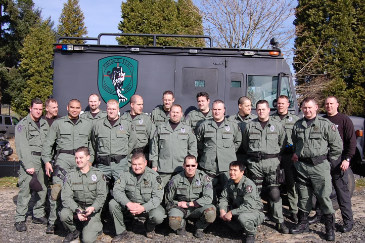 The Gresham SERT Tactical Unit stands in front of their SERT truck.