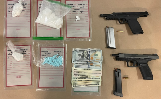 Firearms and drugs on table.
