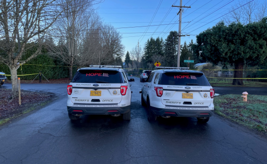 Two patrol cars parked on road in rural Multnomah County.