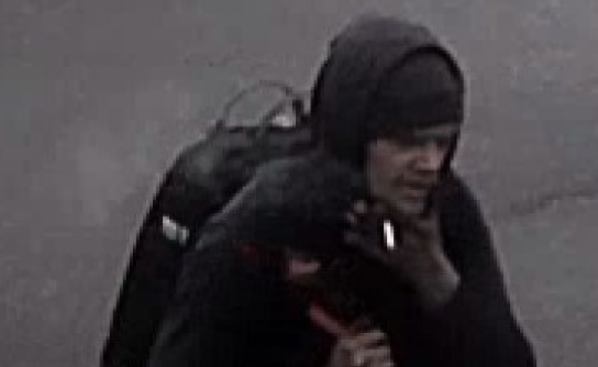 Suspected thief wearing all black with a hood and a backpack
