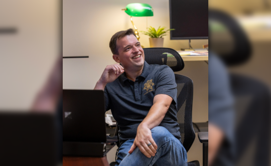 Detective Jonathan Zwick of the Multnomah County Sheriff's Office Detective Unit sits at his desk.