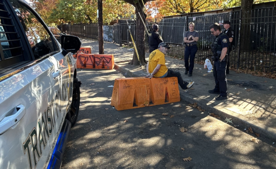 Transit Police on a mission with suspect on sidewalk